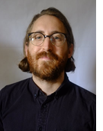 Picture of a white man with a beard wearing glasses