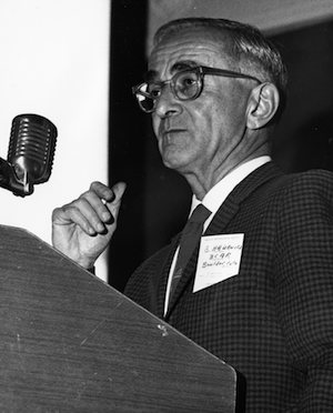 Bernhard Haurwitz speaking at microphone black and white