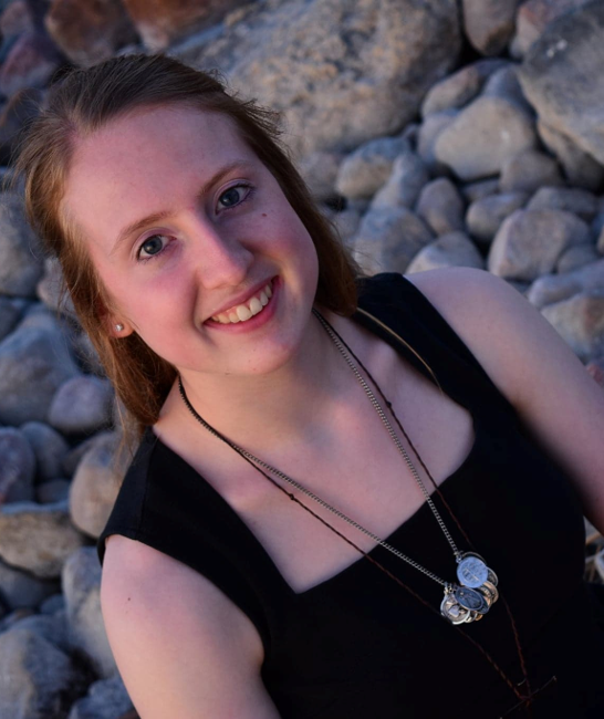 Picture of a young woman smiling on the beach